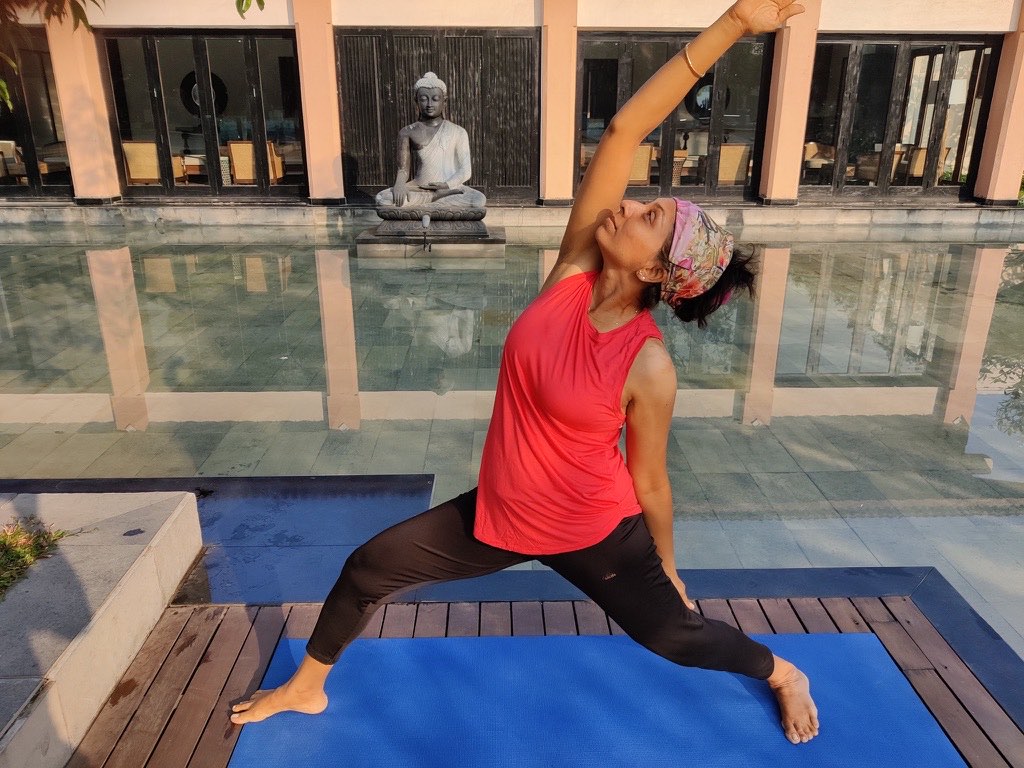 Sheetal Mody in reverse warrior, reaching up and back